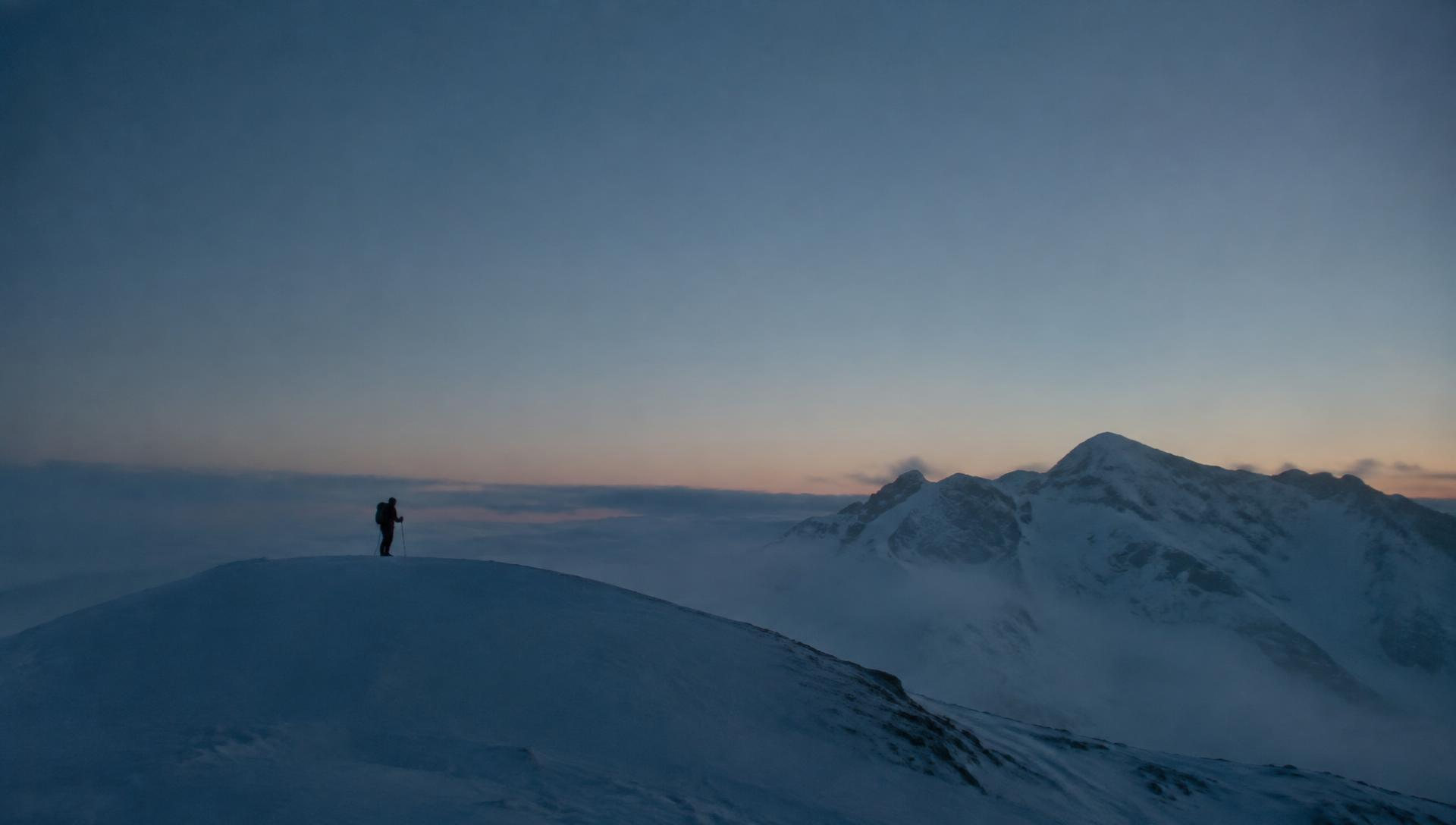 Snowy Nordic mountains at sunset